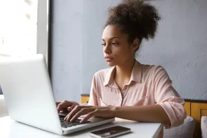 depositphotos 58729377 stock photo young woman working on laptop 1