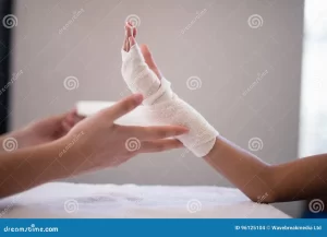 close up female therapist wrapping bandage hand hospital ward 96125104